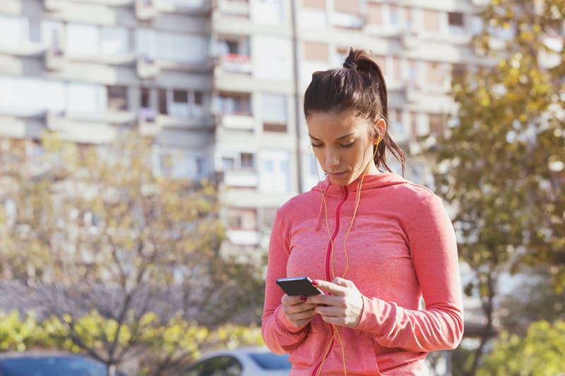 woman deciding what to listen to on headphones