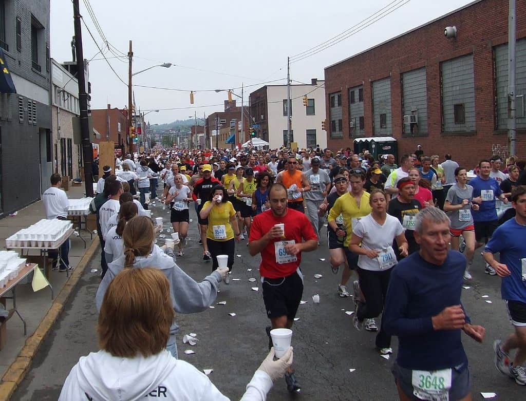 Water stops can get crowded in a marathon.