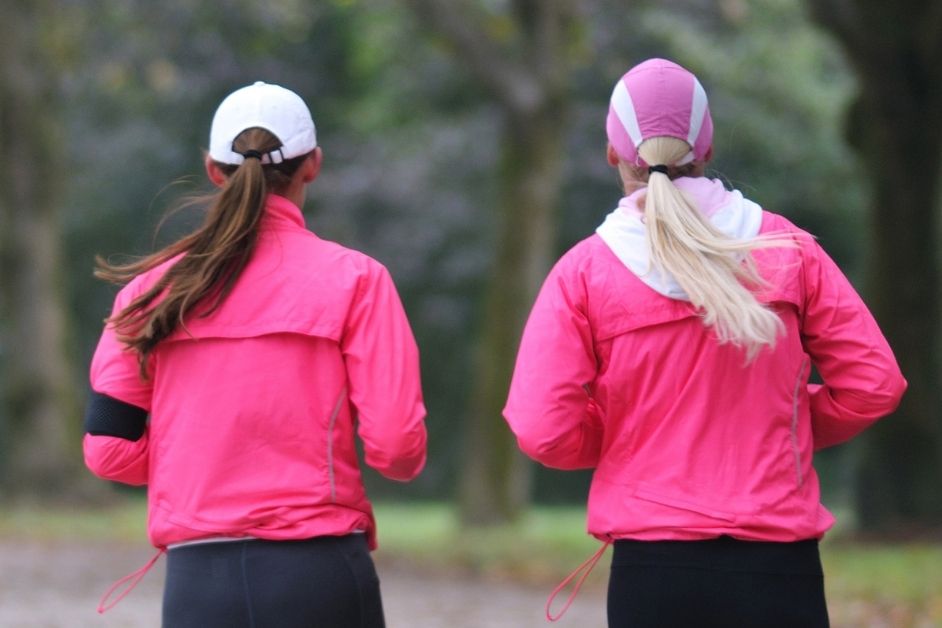 Two women in running hats