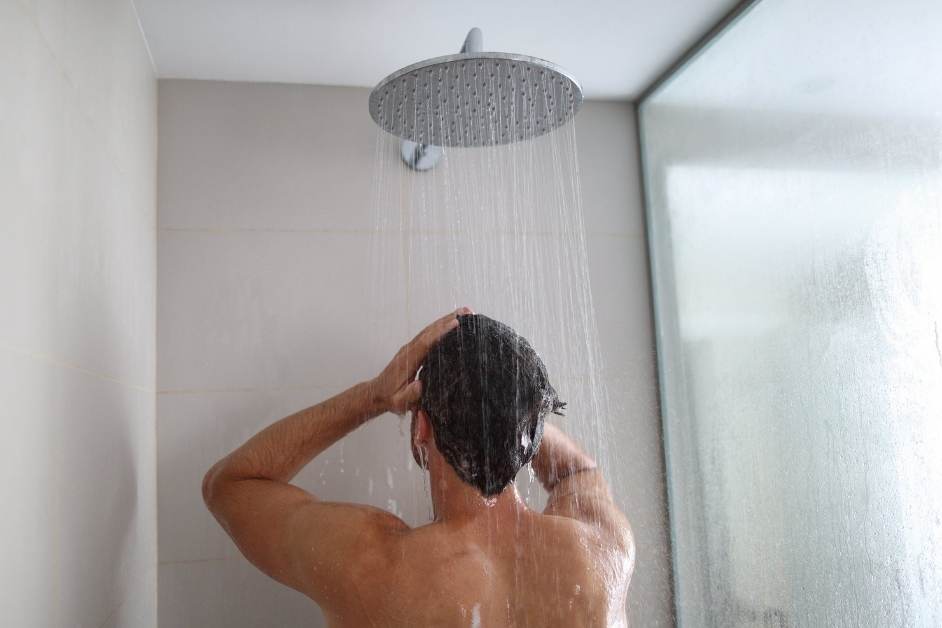 man showering before a run