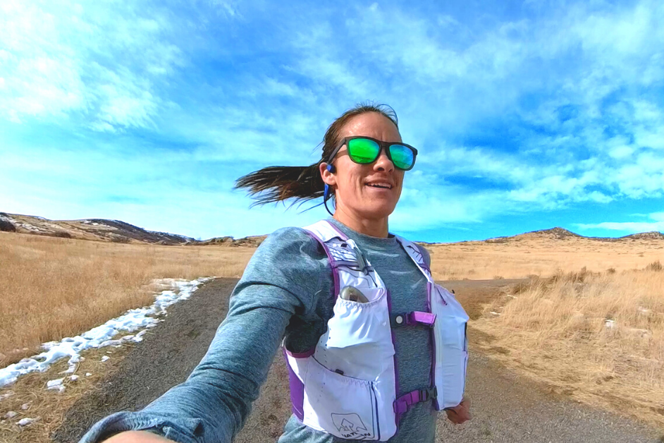 Female runner wearing running vest and sunglasses