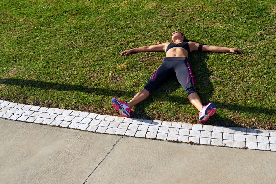 Woman runner tired laying on ground